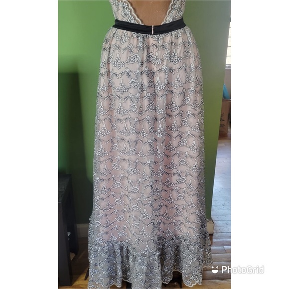 Valentino’s maxi dress is crafted of white, and black scalloped floral lace. - Picture 2 of 7